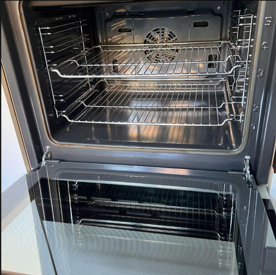 Clean oven interior after ProSpace move-out cleaning — racks, walls and door