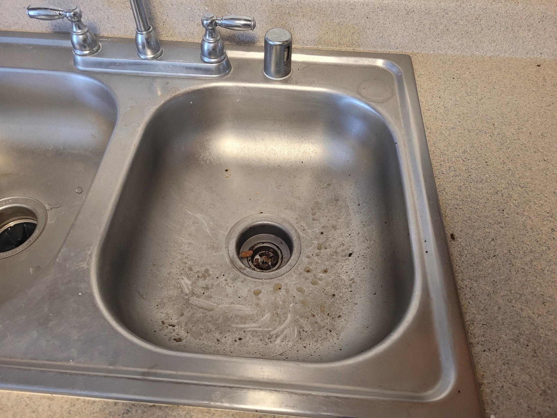 Kitchen sink with residue before cleaning