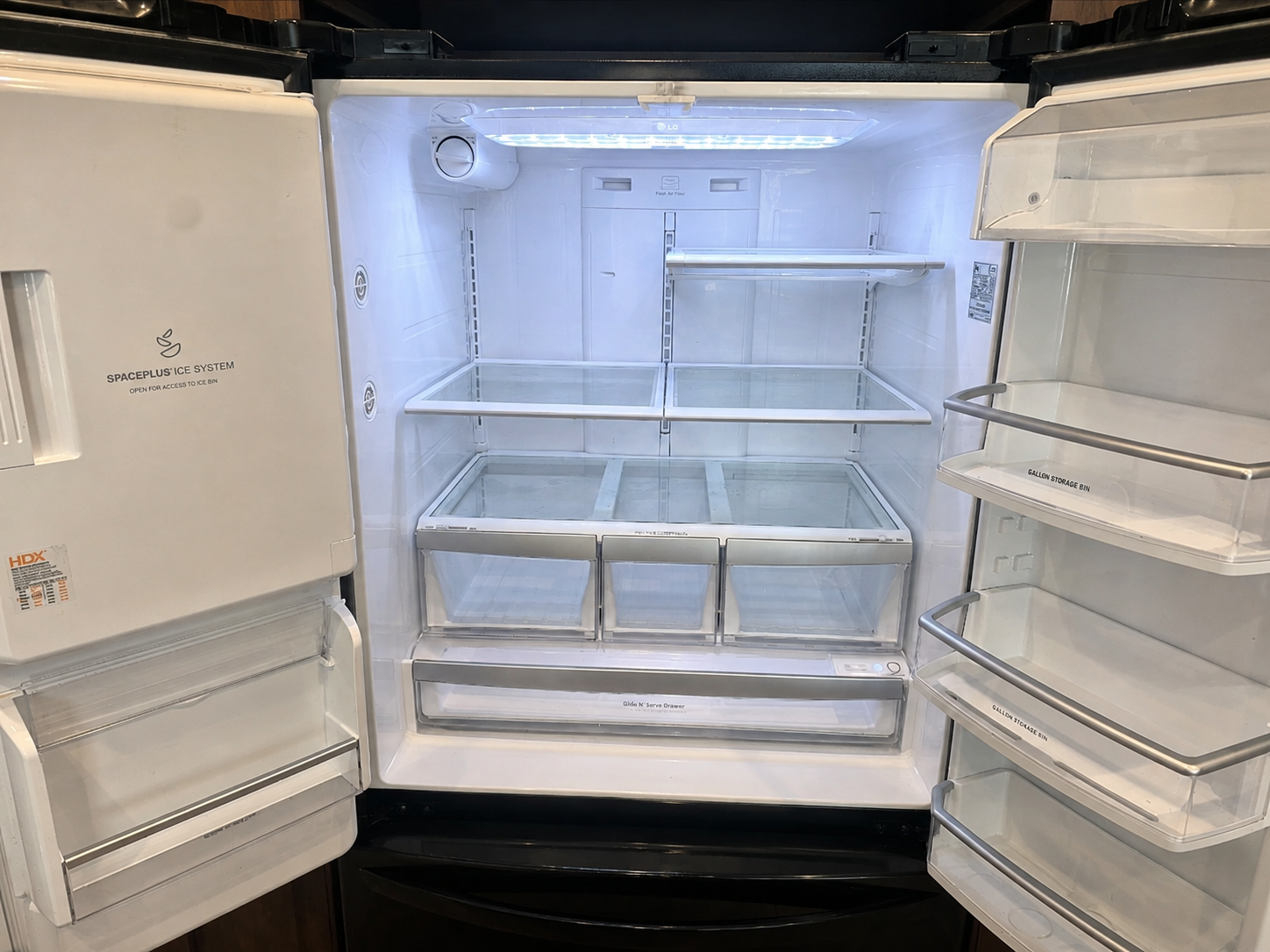Clean refrigerator interior after ProSpace move-out cleaning — shelves, drawers and door bins